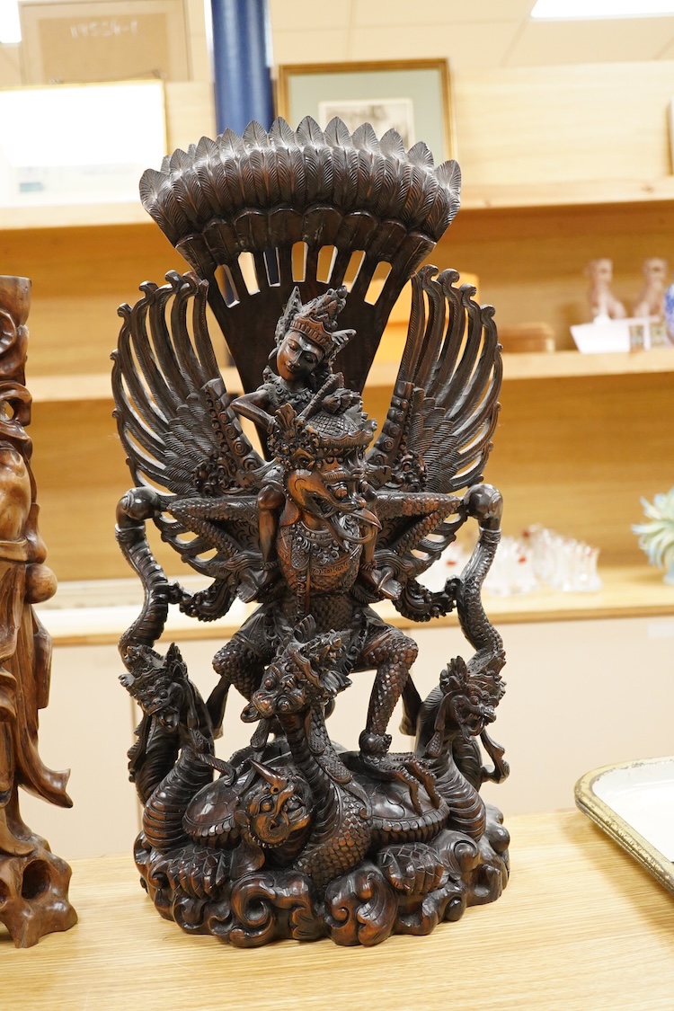 A large Indonesian hardwood Garuda group and a Chinese hardwood figure of a Luohan, largest 61cm high